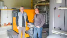 Stéphane Dahirel, aviculteur à Lanouée (56), et Raphaël Lemercier, responsable technique chez GRD thermique, devant la chaudière à biomasse de 130 kW de puissance.