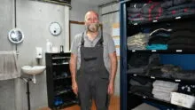 Le responsable d'élevage dans le sas bien rangé avec les vêtements et chaussures propres