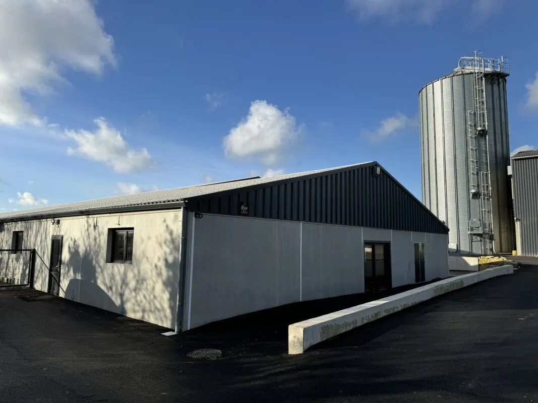 Le sas d'entrée d'un élevage porcin devant un silo-tour.