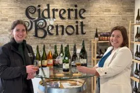Deux femmes trinquent avec des verres de cidre.