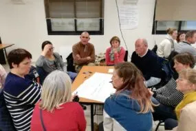 groupe de personnes en réunion autour d'une table