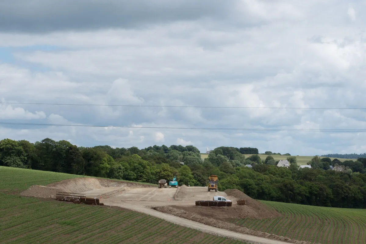 Un chantier de terrassement de bâtiment agricole au milieu de champs de maïs - Illustration Production laitière : Bien chiffrer son projet bâtiment
