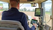Un homme de dos dans une cabine de tracteur