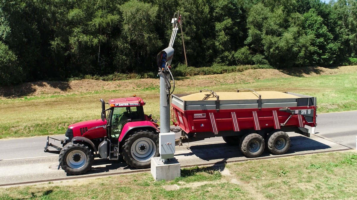 Un tracteur avec une remorque de grain - Illustration Moisson 2025 : Un concentré de grain