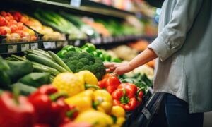 Un étal de légumes avec une personne en train de se servir