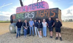 Des personnes devant une structure de paille