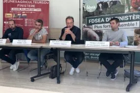 Des personnes à la tribune pendant une conférence de presse