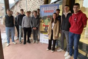 des jeunes étudiants autour d'un panneau "Encadrer, c'est aussi protéger"