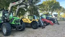 Du matériel de manutention aligné dans un parc ombragé