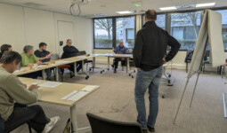 Des personnes et un animateur dans une salle.