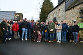 Des personnes devant des maisons de ferme