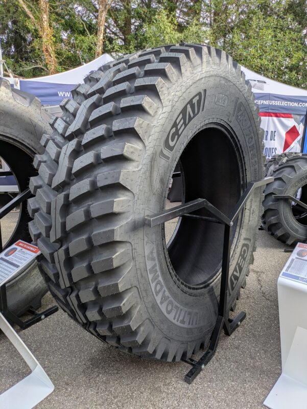 Un pneu de tracteurs exposé dans un salon en extéieur