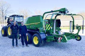 Deux hommes devant le tracteur et le combi presse enrubanneuse