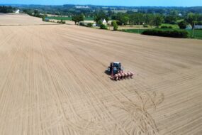 vue drone d'un tracteur en train de semer du maïs