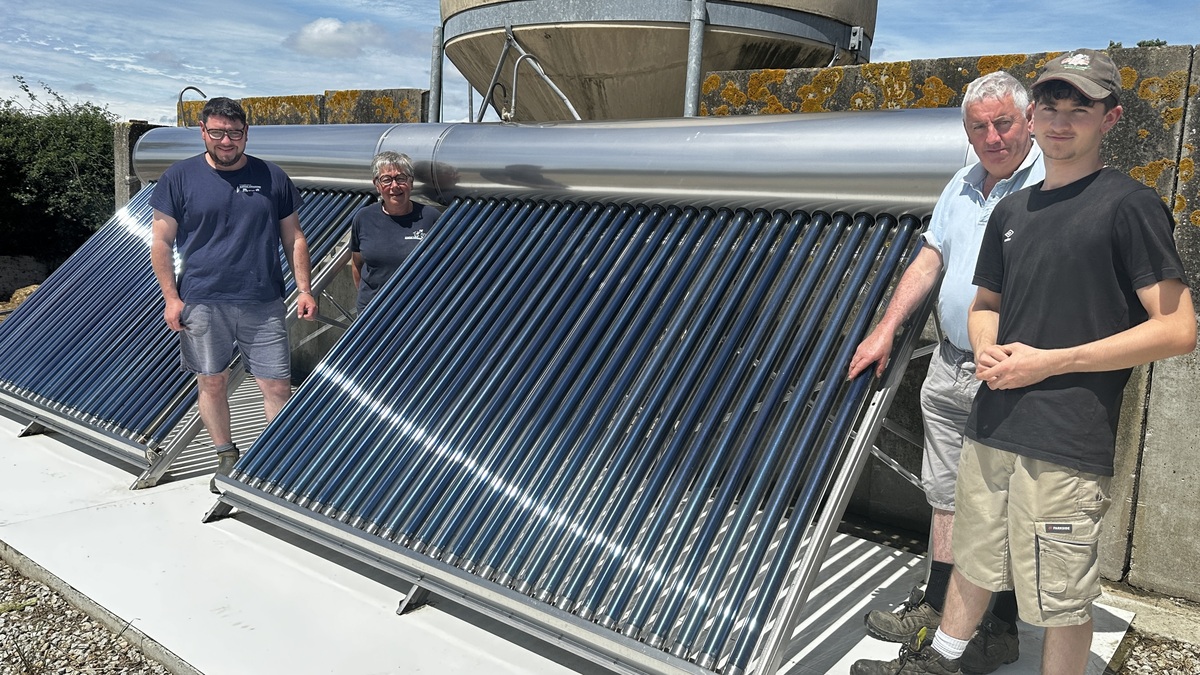Des hommes devant une installation solaire thermique - Illustration Le solaire thermique au service des robots de traite