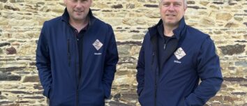 Deux hommes devant un mur de pierre