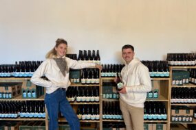Un jeune couple devant un rayonnage de bouteilles de bières