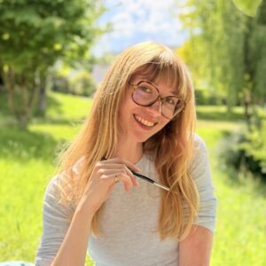 Une jeune femme souriant dans un paysage de campagne