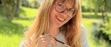 Une jeune femme souriant dans un paysage de campagne