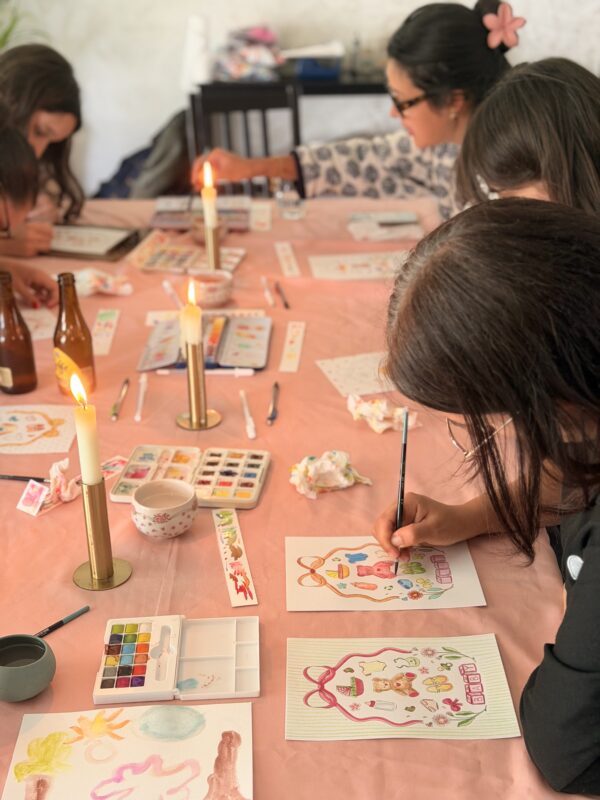atelier d'initiation à l'aquarelle avec des stagiaires qui peignent à une table