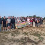 Un groupe de personnes pose pour une photo dans un champ
