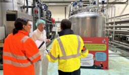 trois personnes échangeant dans une industrie agro-alimentaire